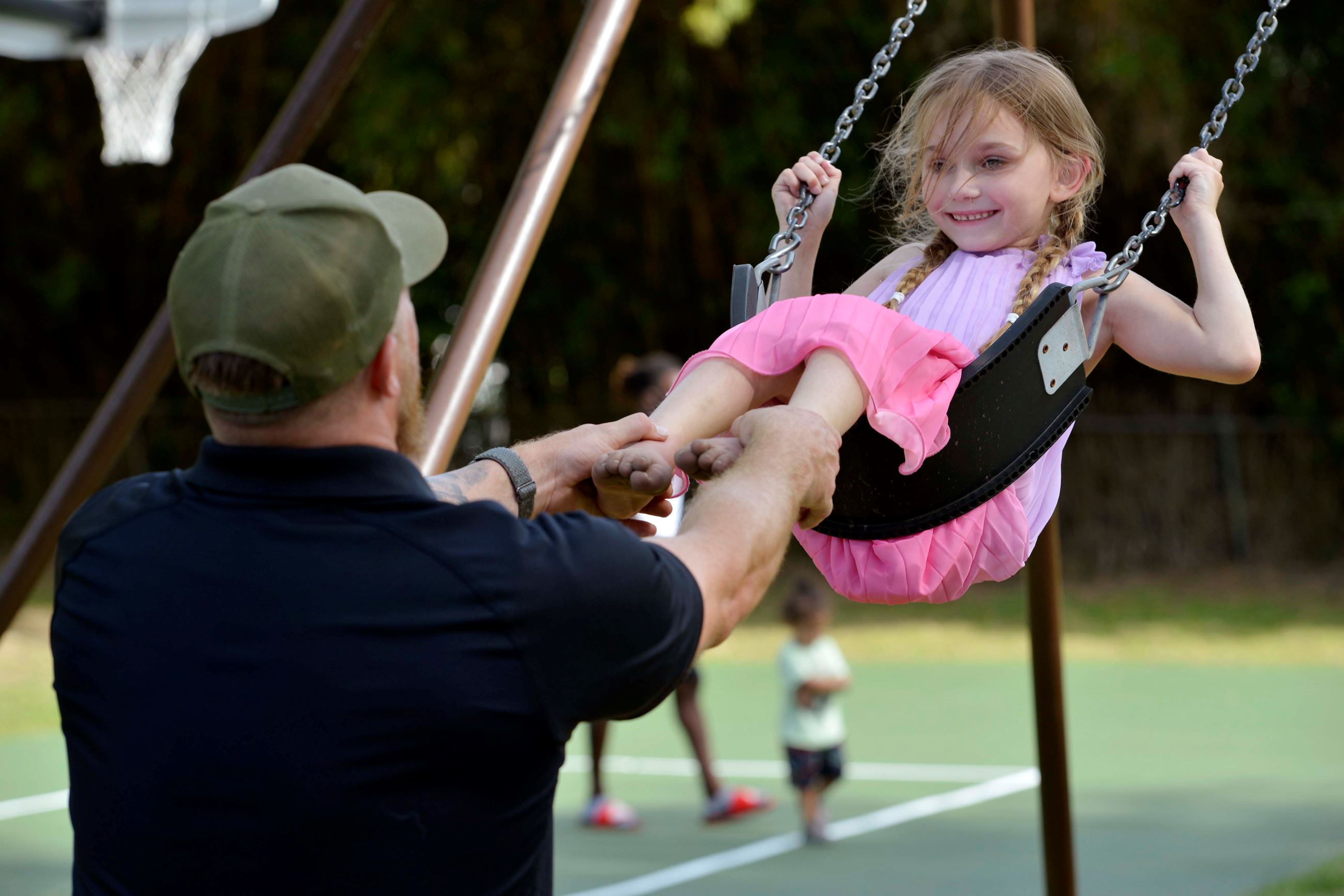A father pushes his daughter on a swing Cecelia Park is in Fort Walton Beach.