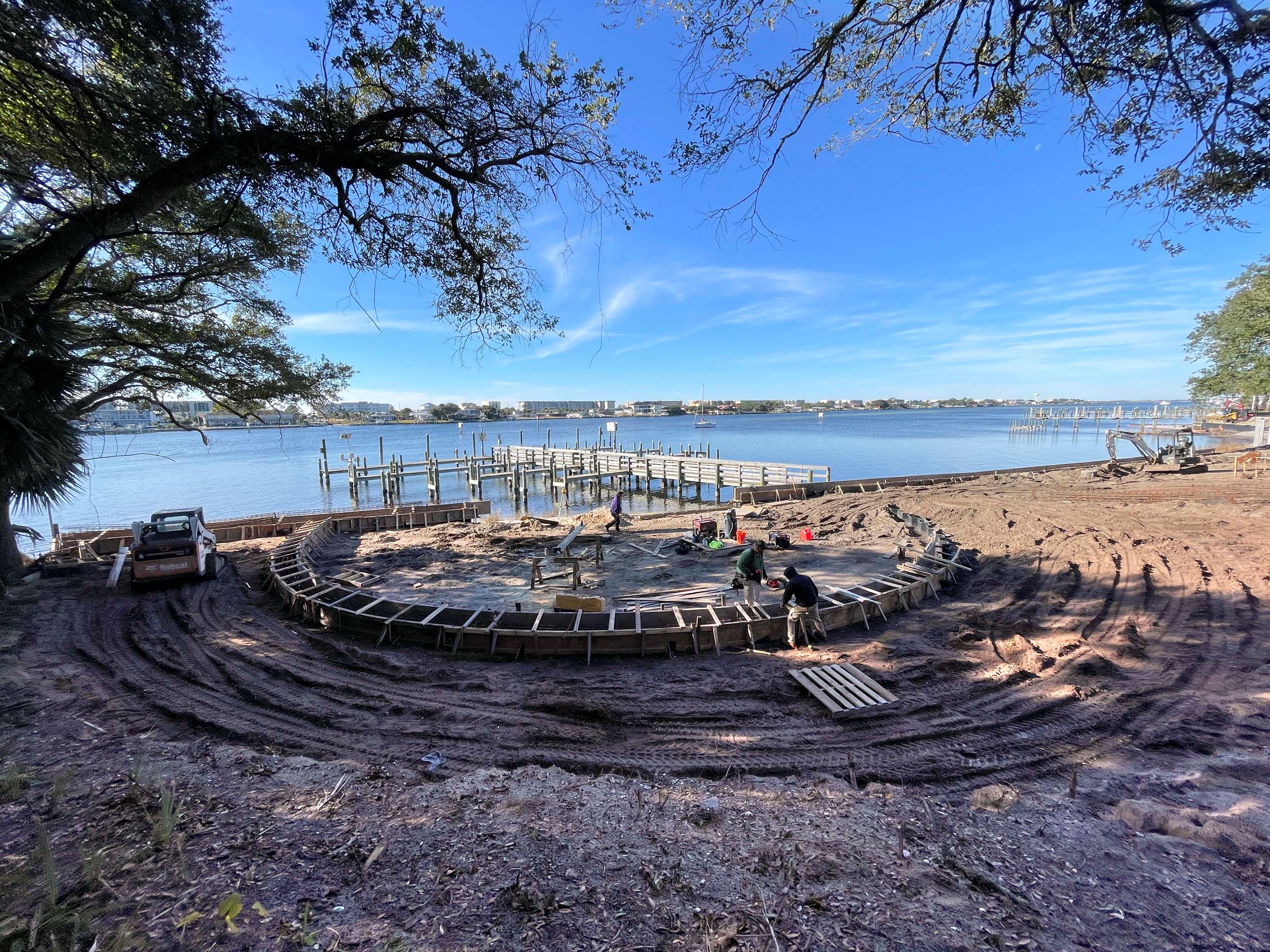 A construction crew works on the semi-circular "pocket beach" that is located on the east side