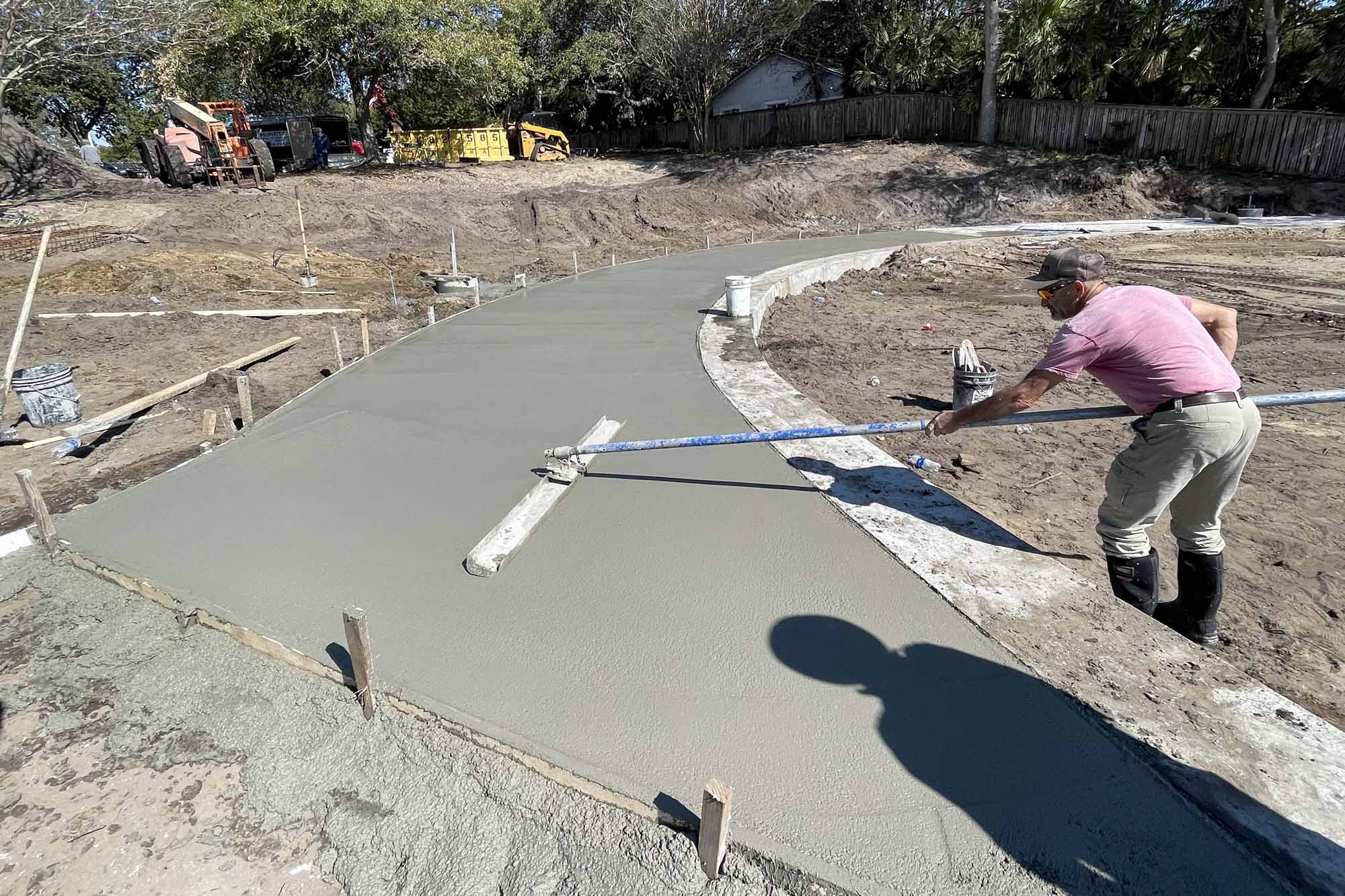 Construction crews pour concrete as part of renovations of the Fort Walton Beach Landing Park.