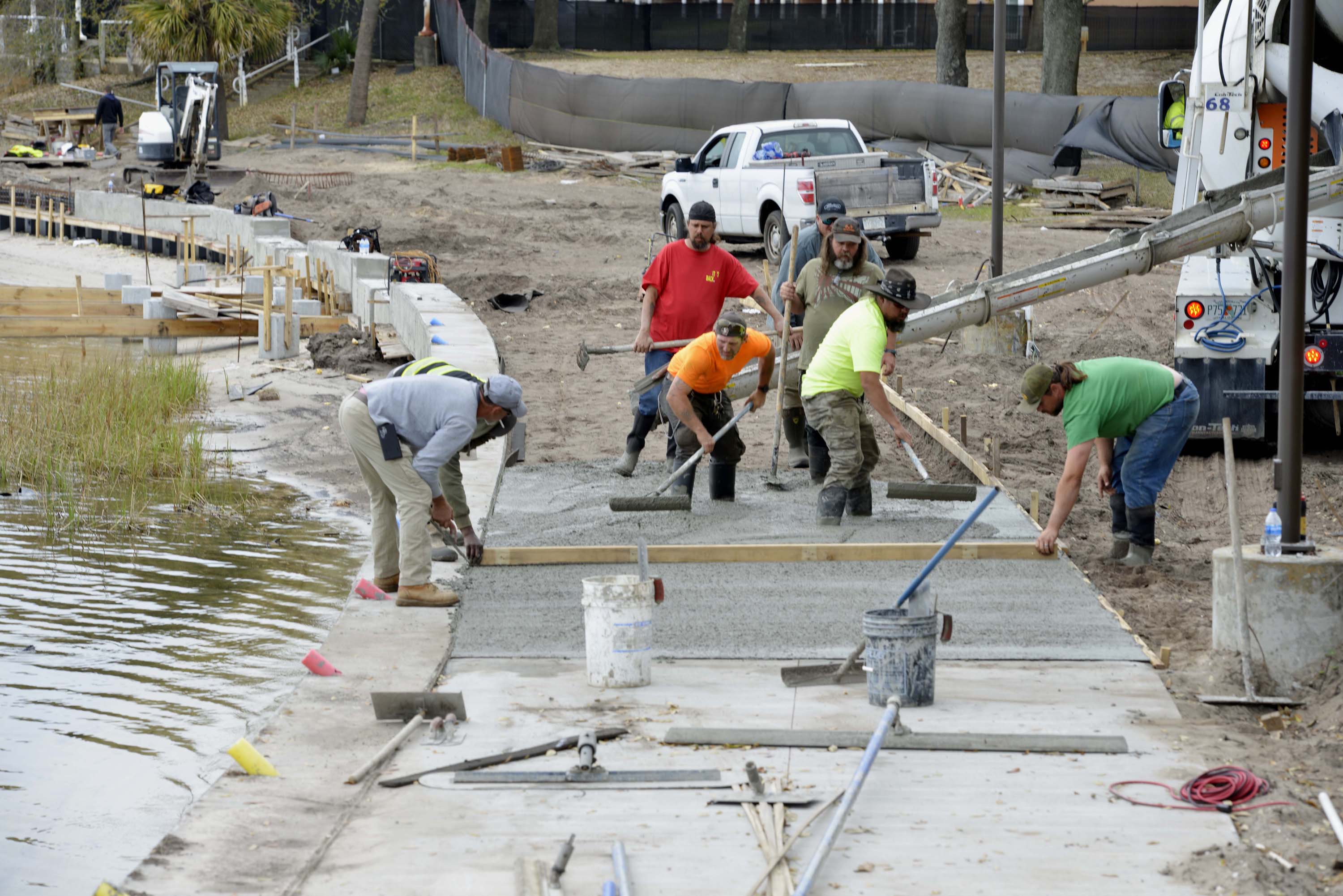 A construction crew pours concrete for the new boardwalk at the Fort Walton Beach Landing.