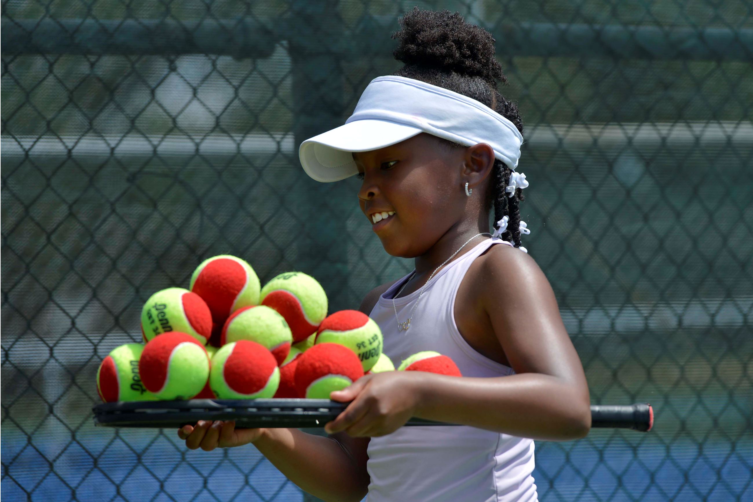 A tennis camp participant practices at the Fort Walton Beach Tennis Center.