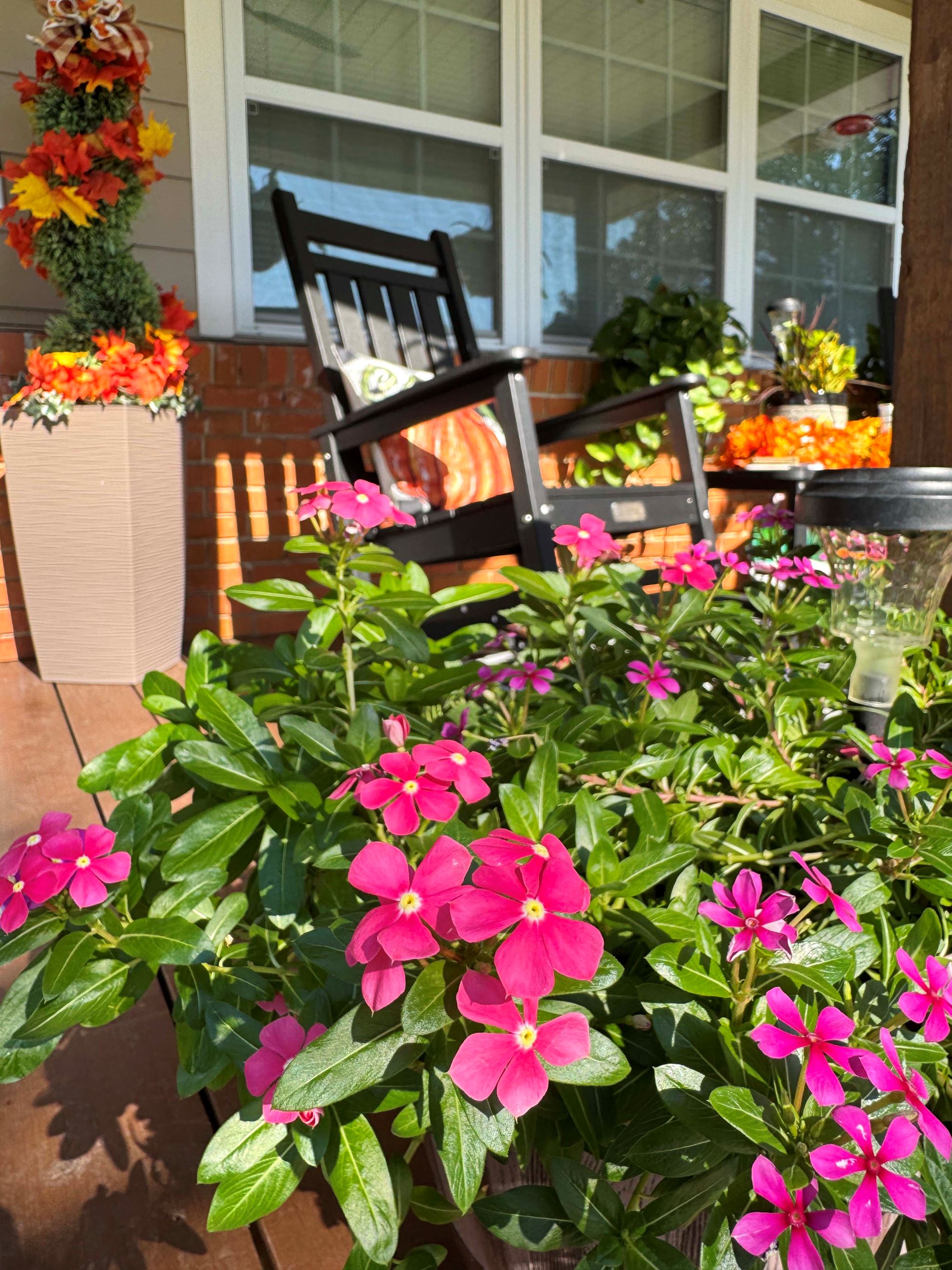 Periwinkles and other colorful flowers adorn a porch at a Fort Walton Beach home.