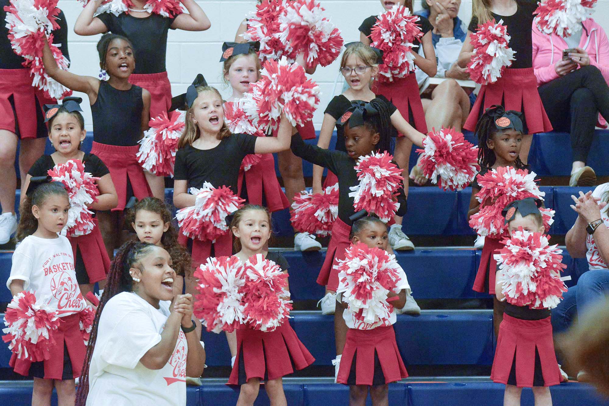 Youth Cheerleaders cheer at a basketball game at the Fort Walton Beach Recreation Center.