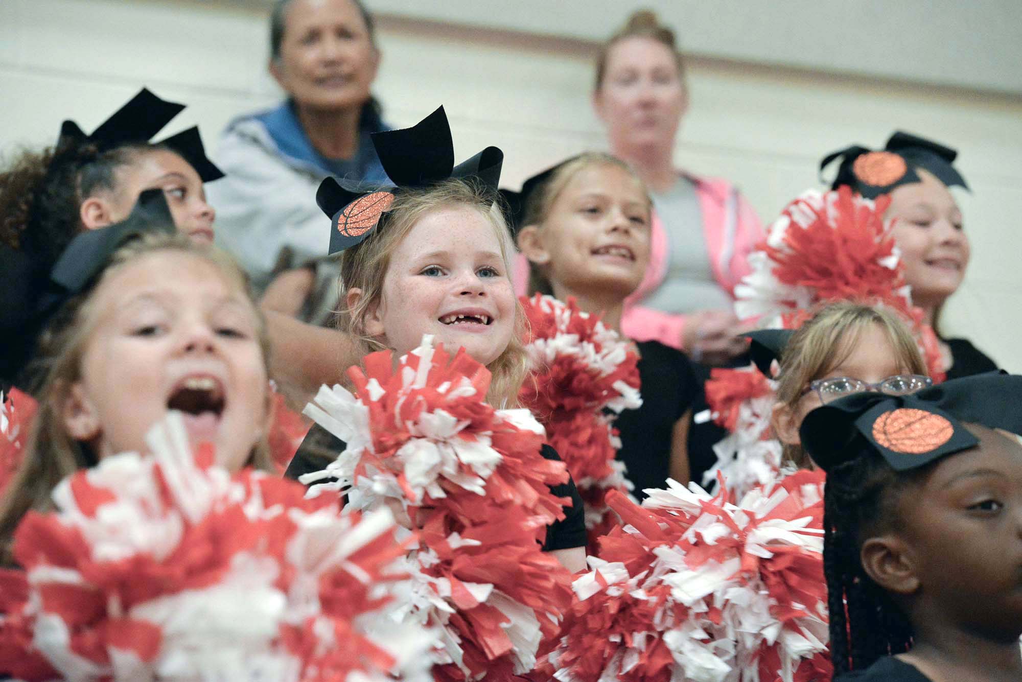 Youth Cheerleaders cheer at a basketball game at the Fort Walton Beach Recreation Center.